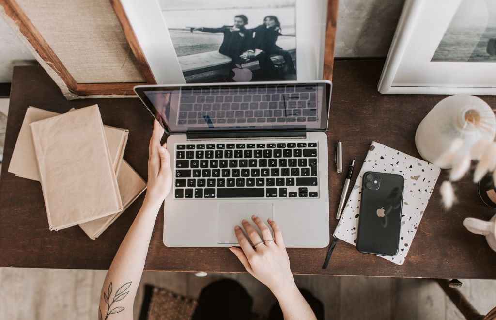 A organized workspace with laptop, smartphone and agenda