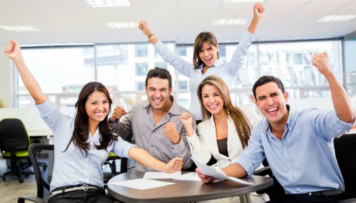 a team of 5 people celebrating
