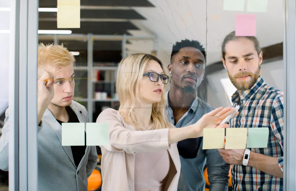 a team of four people organizing their workload