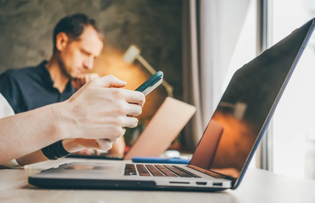 Person distracted by her smartphone during work time