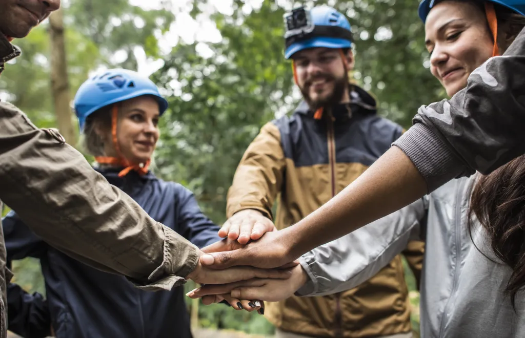 a team of four people having an outdoor team building activity